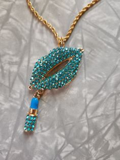 Blue rhinestone lips charm necklace. This is for 1 necklace. It is on a gold plated stainless steel 18 inch chain with a 2 inch extender. If you love statement jewelry than this piece is for you. Or wear to an 80's themed party.  If you have any questions please feel free to contact me.  Thank you for shopping at my store. Have a Totally Awesome Day! 😎 Trendy Bling Necklaces For Gifts, Trendy Bling Necklace For Gift, Trendy Necklace For Gift, Trendy Gold Rhinestone Necklace With Bling, Trendy Gold Rhinestone Necklace Gift, Rhinestone Lips, Totally Awesome, Blue Rhinestones, Statement Jewelry