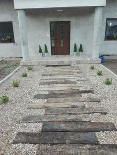 a long wooden walkway in front of a house