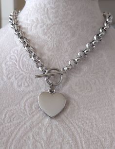 Handmade Silver Color Stainless Steel Chunky Heart Necklace, elegant polished Stainless Steel Heart Pendant and Toggle Clasp. 22mm wide Polished Silver Color Heart Pendant. ~8mm Wide Stainless Steel Silver Color Chain. Available in Bracelet style. **Total length is for the chain and toggle only not including the heart pendant** Same Necklace in Gold Color Stainless Steel available on the below listing: https://www.etsy.com/listing/693500869/gold-heart-necklace-all-gold-stainless?click_key=b01016 Chunky Heart Necklace, Boho Jewels, Color Heart, Chunky Chain Necklaces, Necklace Elegant, Toggle Necklace, Necklace Chunky, Necklace Chain Lengths, Gold Heart Necklace