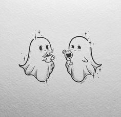 two ghost stickers on the side of a white paper with black ink, one holding a