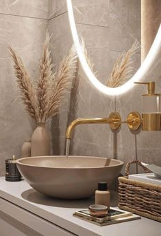 a bathroom sink sitting under a round mirror