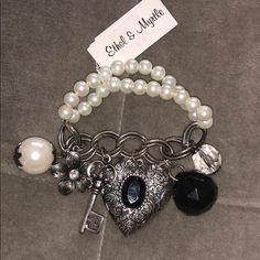 Ethel And Myrtle Pearl & Silver Charm Bracelet With Locket - 6 Charms - Pearl With Flower Embellishments, Flower With Rhinestone Embellishment, Silver Key, Silver Heart With Black Rhinestone Embellishment Opens As A Locket, Black Crystal Ball, Clear Crystal Ball - Silver And Pearl Bracelet, Stretches Over Wrist Bracelet Charms Aesthetic, Locket Aesthetic, Edgy Bracelets, Juicy Couture Charms Bracelet, Funky Style, Flower Embellishments, Junk Jewelry, 2000 Fashion, Grunge Outfit