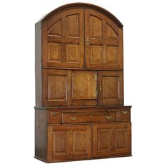 a large wooden cabinet with two doors and drawers on the top, in front of a white background