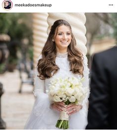 a woman in a wedding dress holding a bouquet