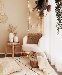 a living room filled with furniture and plants on top of a white rug next to a window