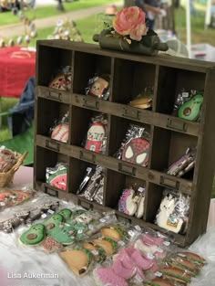 a display case filled with lots of different types of cookies and pastries on top of a table