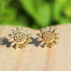 These pretty brass sunflower stud earrings are made with raw brass and feature amazing details in the design.  They make amazing gifts for anyone who loves sunflowers for brithdays, graduations, Christmas, stocking stuffers, Mother's Day, anniversaries, Valentine's Day or a just because gift.   Earring Details ❤️Made with raw brass ❤️Measure approximately 15mm ❤️Soft clear silicone earring backings for comfort ❤️Packaged on a high quality earring card and in a gift box with satin ribbon ❤️Not recommended for wear in a pool or the ocean Buy your succulent shaped stud earrings here...  https://www.etsy.com/listing/795089656/succulent-stud-earrings?ref=shop_home_active_6&crt=1 Buy your beach stud earring gift set here...  https://www.etsy.com/listing/717979389/sandy-beach-turquoise-druzy-stud Bohemian Sunflower Design Flower Earrings As Gift, Bohemian Sunflower Earrings For Gift, Bohemian Sunflower Design Earrings For Gift, Bohemian Sunflower Earrings As Gift, Metal Sun Design Earrings For Gift, Gold Nickel-free Flower Earrings As Gift For Her, Gold Sunflower Adjustable Flower Earrings, Brass Flower Earrings For Gift, Adjustable Gold Sunflower Earrings