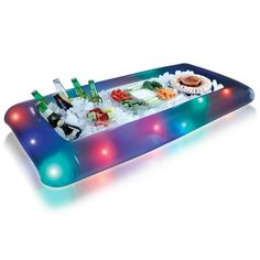 an inflatable food tray with sushi and drinks on it is lit up