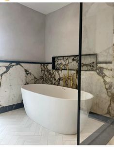 a bath tub sitting inside of a bathroom next to a walk - in shower stall