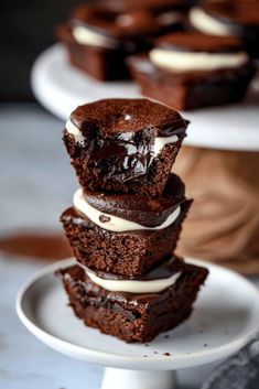 three brownies stacked on top of each other with white frosting and chocolate chips