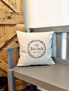 a white pillow sitting on top of a wooden bench