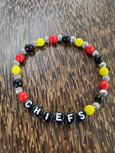 Kansas City Chiefs beaded bracelet made with red, yellow, and black glass and pewter beads. We can also personalize it with any names. Kc Chiefs Beaded Bracelet, Personalized Red Name Bracelet With Round Beads, Red Beaded Name Bracelet With Round Beads, Red Beaded Name Bracelet, Customizable Black Beaded Bracelets, Black Beaded Name Bracelet With Round Beads, Black Beaded Name Bracelet, Personalized Yellow Beaded Bracelets, Personalized Yellow Beaded Bracelets With Round Beads