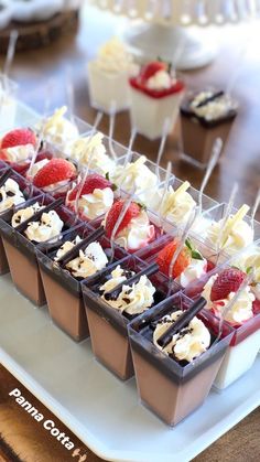 desserts are arranged in trays with strawberries and cream on them, along with chocolate