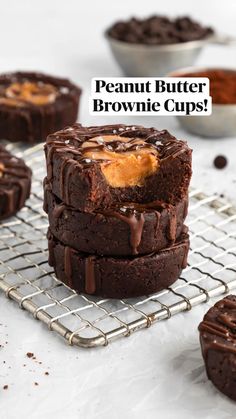 chocolate cookies with peanut butter in the middle on a cooling rack next to other desserts