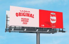 a red and white advertisement for la roja original on a street light pole in front of a blue sky