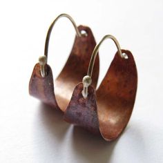 These sweet, petite hoops make great "every day" earrings. They are hammered, flame patinated copper. The color on the copper is due to the Flame-patina, which is a spontaneous process and allows for an array of red/orange colors patterns, no two are exactly alike. Sterling ear wire fits into hole in back of hoop to close. Sweet, petite and perfect for everyday! 3/4" diameter. Diy Copper Earrings Handmade Jewelry, Diy Copper Earrings, Unique Rust-colored Earrings With Ear Wire, Unique Rust Earrings With Ear Wire, Unique Hammered Hoop Earrings, Artisan Nickel Free Copper Hoop Earrings, Handmade Small Hoop Copper Earrings, Handmade Small Copper Hoop Earrings, Artisan Copper Hoop Earrings Nickel Free