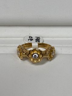 a gold ring with two diamonds on it