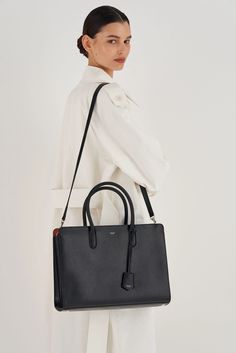 [vc_row][vc_column width=”1/3″][vc_column_text text_larger=”no”] Oroton Women’s Muse 15″ Worker Tote   Oroton Muse 15″ Worker Tote The Oroton Muse 15” Worker Tote and Pouch in black is crafted from a double textured leather. It combines both saffiano and smooth calf leather, to create a luxurious day-bag. Internally the laptop bag has 5 main compartments, a removable laptop pouch and an internal zip pouch and slider pocket. Fitted with two griptop h Black Saffiano Leather Briefcase For Work, Modern Textured Leather Briefcase For Work, Modern Black Saffiano Leather Briefcase, Black Textured Leather Briefcase For Work, Elegant Textured Leather Laptop Bag For Work, Black Smooth Grain Briefcase For Everyday Use, Black Epsom Leather Bag For Work, Everyday Black Briefcase With Smooth Grain, Everyday Black Smooth Grain Briefcase