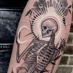 a man with a skeleton tattoo on his arm