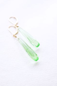 Long Gold, Peridot Quartz Teardrop Earrings, No. EGL031 :*About This Piece*: ♦︎ Elegant and classy, these bright green Peridot Quartz Drops have a vintage appeal with a timeless elegance hung from gold filled lever back earrings. ♦︎ Length - 2.2 in (55 mm) ♦︎ Width - .3 in (7 mm) ♦︎ All items from my shop are packaged in padded cardboard jewelry boxes. Custom gifting options available upon request. ♦︎ Visit my shop for more here: https://www.etsy.com/shop/storygirlcreations ♦︎ Are you looking fo Green Drop Teardrop Earrings For Formal, Green Faceted Teardrop Earrings, Green Teardrop Earrings For Formal Occasions, Formal Green Teardrop Drop Earrings, Green Faceted Earrings For Wedding, Green Teardrop Earrings For May Birthstone, Green Teardrop May Birthstone Earrings, Green Long Drop Earrings, Green Long Drop Earrings For Formal Occasions