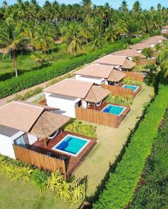 an aerial view of several houses with swimming pools