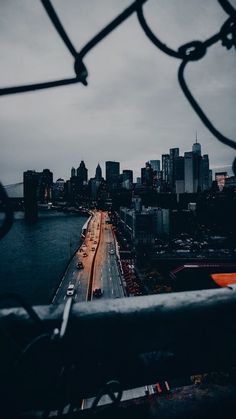 a view of the city from an overpass with cars driving down it's road