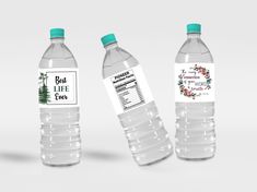 three bottled water bottles with labels on them