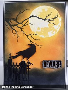 a halloween card with a crow on a fence in front of a full moon and beware sign