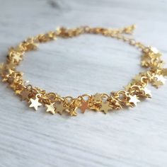 Tiny clusters of matte gold finish miniature star fringe, finished with an adjustable chain and lobster claw clasp. 14k gold plated brass. { M e a s u r e m e n t s } Bracelet shown adjusts to fit approx 6.25 - 8 in (15 - 19.5cm). Each little star is approx 1/4 inch {approx 5mm} tall. Please double check measurements on your own wrist prior to any purchase, if you have any doubt or concern about the fit. I'm happy to shorten the length free of charge if you leave me a note at checkout with your Lucky Charm Bracelet, S Bracelet, Good Luck Bracelet, Good Luck Gifts, Star Chain, Star Bracelet, Bar Earrings, Gold Star, Lucky Charm