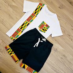 This Tshirt and cotton pull up shorts Set combines comfort and style with its l pull up shorts and unique African print detailing. Perfect for both girls and boys and teens, this casual wear is easy to maintain with its machine washable material. Experience an eff ortless fit and a touch of culture with this must-have set. This set adds an African-inspired flair to your wardrobe. The Africa print detail on both the tshirt and shorts adds a unique touch to this casual, unisex set. This set offers Tshirt And Shorts, Africa Print, Printed Aprons, African Inspired, Pull Up, Pull Ups, Shorts Set, African Print, African Fashion