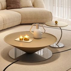 a coffee table with two candles on it