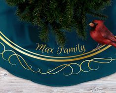 a red bird sitting on top of a tree branch next to a blue banner that says max family