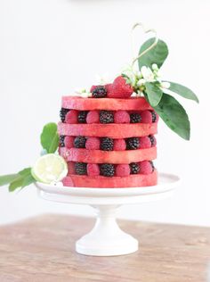 there is a cake made out of watermelon, raspberries and limes