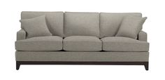 a gray couch with four pillows on it's back and two sides facing each other