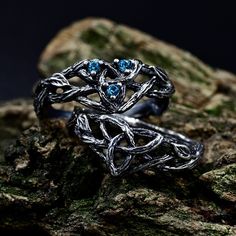 Crafted from sterling silver, our matching Viking wedding bands boast intricate designs inspired by celtic forests, perfect for couples seeking a unique symbol of their love. The wiccan love knot engagement ring adds a touch of mystique, while the aquamarine fantasy branch enhances its ethereal charm. This non-traditional set, featuring delicate branch and leaf motifs intertwined with celtic trinity knots. Characteristics: Metal - Recycled solid sterling silver  Stone - Cubic Zirconia Finish - Oxidized. View all silver celtic engagement rings: https://www.etsy.com/shop/TinyShinyJewel?ref=seller-platform-mcnav&section_id=44336419 Care instructions: To care for the ring, avoid contact with water and chemicals such as perfumes and lotions. When the ring is not in use, store it in a dry, cool Viking Wedding Ring Sets, Fantasy Wedding Rings Couple, Viking Engagement Ring, Magical Sterling Silver Wedding Jewelry, Fantasy Adjustable Wedding Jewelry, Adjustable Fantasy Jewelry For Weddings, Fantasy Style Adjustable Wedding Jewelry, Silver Fantasy Rings For Anniversary, Fantasy Silver Rings For Anniversary