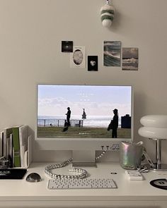 a computer monitor sitting on top of a white desk