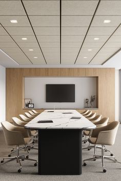 a conference table with chairs around it and a flat screen tv on the wall