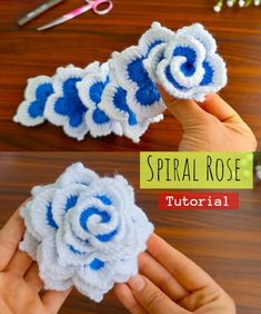 crocheted flower with blue and white stripes is shown in the process of being made