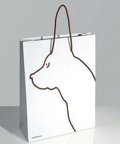 a white shopping bag with a dog's head drawn on it