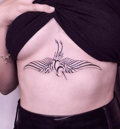 a woman with a bird tattoo on her stomach