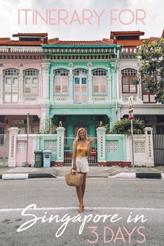 a woman standing in front of a multi - colored building