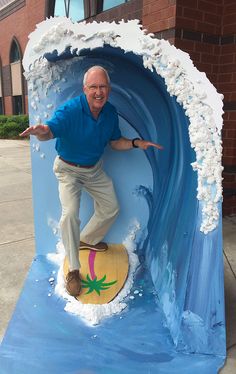 an older man on a surfboard in a fake wave