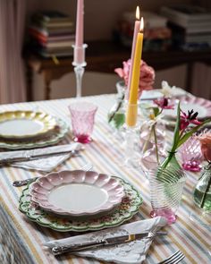 the table is set with plates and silverware