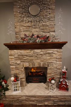 a stone fireplace with christmas decorations on the mantle