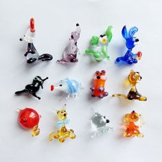 a group of glass figurines sitting next to each other on a white surface