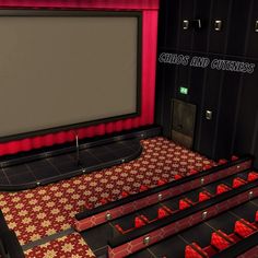 an empty auditorium with rows of seats and a projector screen in the center, surrounded by red curtains