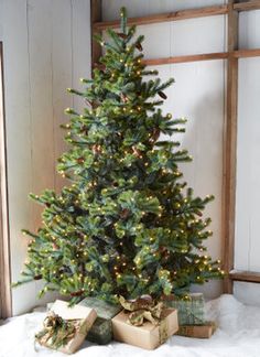 a small christmas tree with presents under it