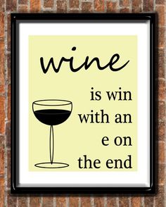 a framed poster on a brick wall with the words wine is win with an e on the end