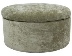 a round ottoman with a green velvet cover