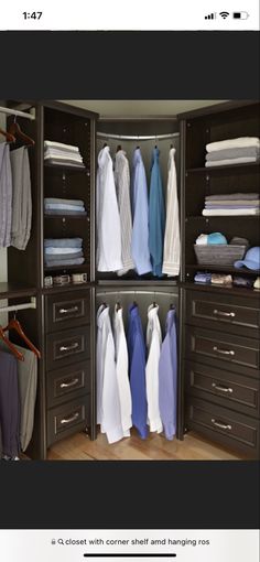 an organized closet with clothes hanging in it